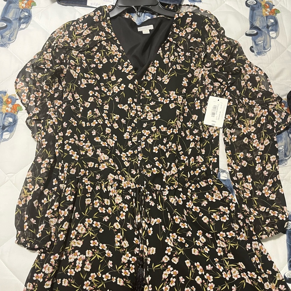 Flower shorts romper. Ties at the waist. Never worn.